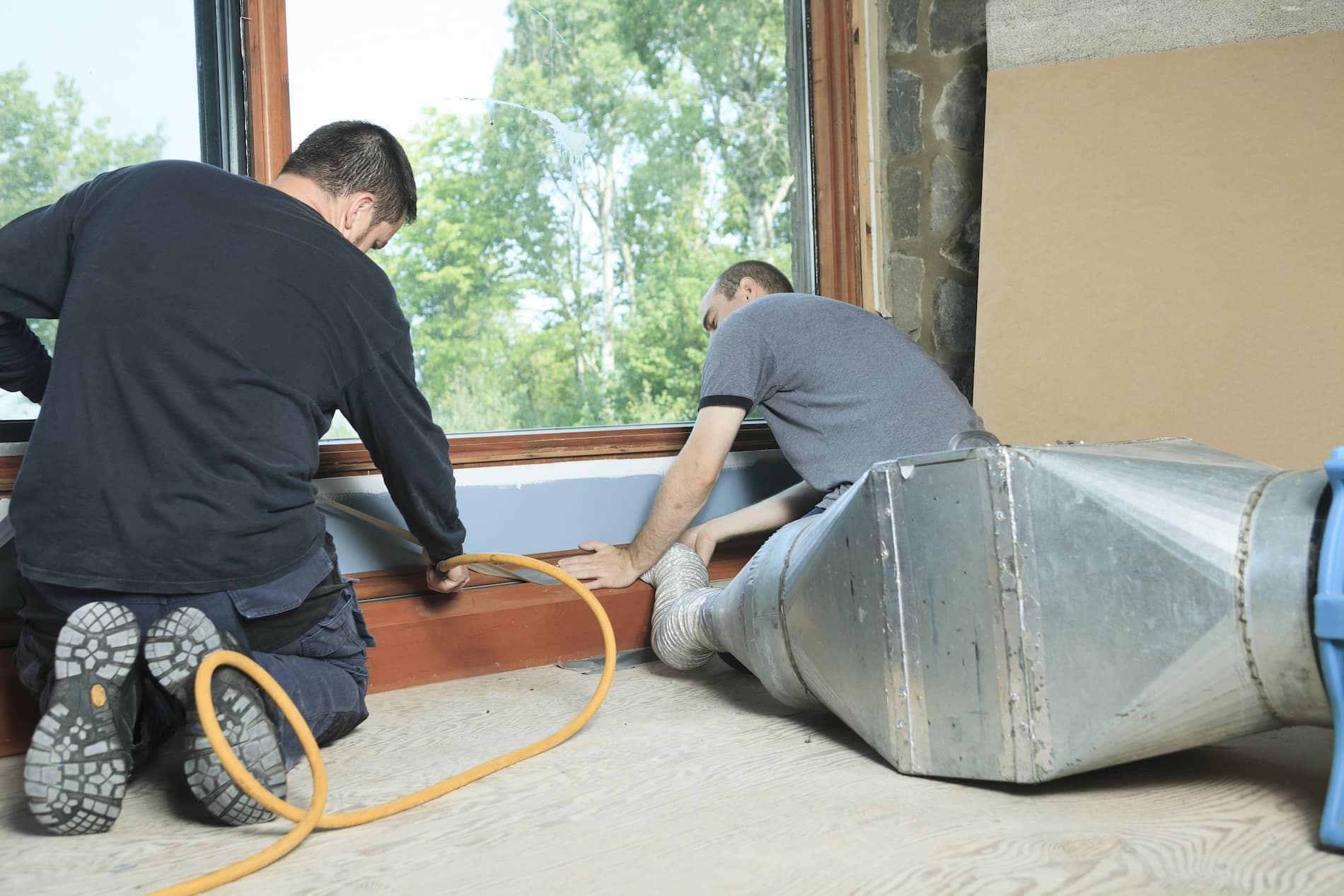 2 air duct cleaners working on a new home installation